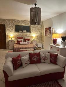 a living room with a couch and two beds at La Casa di SASI in Sabaudia +59 photos