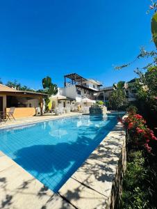 a swimming pool in front of a house at Pousada Pérola do Mar in Tamandaré