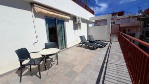 a patio with chairs and a table on a balcony at Hotel Celymar in Benidorm