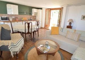 a living room with a couch and a table at Joli Canard in Badefols-dʼAns