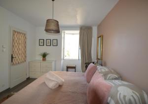 a bedroom with a large bed and a window at Joli Canard in Badefols-dʼAns