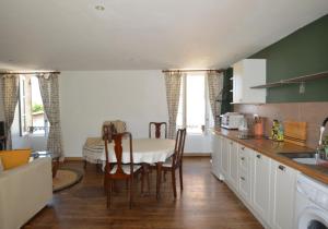 a kitchen with a table and a dining room at Joli Canard in Badefols-dʼAns +11 photos