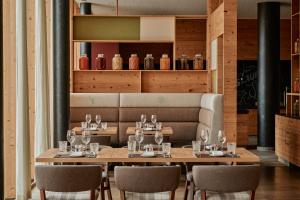 a dining room with a table with wine glasses at Falkensteiner Hotel Schladming l 4 Star Superior in Schladming