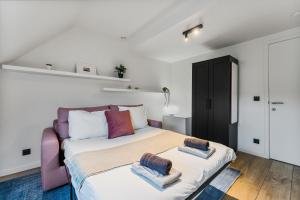 a bedroom with a bed with two pillows on it at Modern & Spacious House with Wellness in Kortrijk