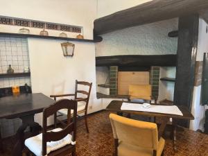 a kitchen with a table and chairs in a room at Locanda Motto del Gallo in Taverne