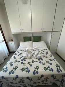 a bed with a stuffed animal laying on it at Residence The Yellow Fish with Pool in Manerba del Garda +23 photos