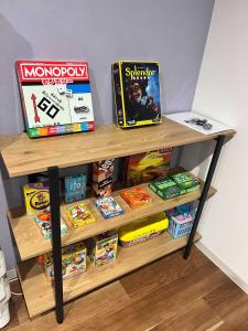 a wooden shelf with games and books on it at Villa Shigin in Nakafurano