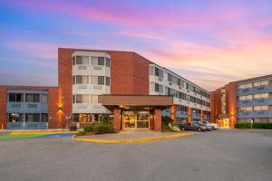 a building with a parking lot in front of it at Best Western Plus Ottawa City Centre in Ottawa