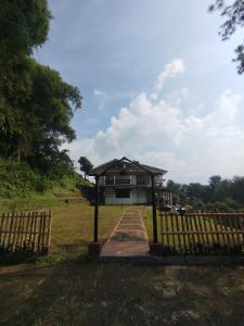 a building with a gate in front of it at Villa Mega molek in Pondok Cipaseban