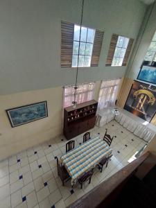 a large room with a table and chairs in it at Villa Mega molek in Pondok Cipaseban +4 photos