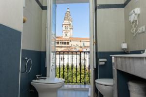 a bathroom with a toilet and a view of a building at Casa Celsa-Barbantes in Santiago de Compostela +95 photos