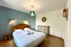 a bedroom with a large bed with a wooden headboard at Escapade détenteSt-Valery & Le Crotoy à 15 min in Noyelles-sur-Mer