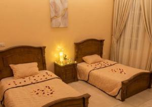 a bedroom with two beds and a window at HK Pyramids Guest House Hospitality& Kindness in Cairo