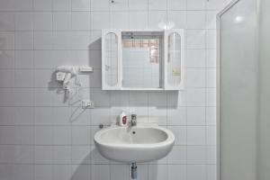 a white bathroom with a sink and a mirror at Apt Venice City in Mestre