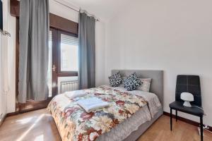 a bedroom with a bed and a chair in it at Apt Venice City in Mestre