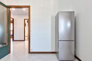 a stainless steel refrigerator in a hallway with a mirror at Apt Venice City in Mestre