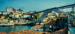 a view of a bridge over a river with buildings at FamilyHub - EcoHost - Spacious 3-bedroom apartment for 8 people with AC and parking near Porto and the beaches in Senhora da Hora