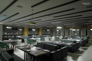 a dining room with tables and chairs in a restaurant at Hotel Shubham Prestige RC Puram in Lingampalli