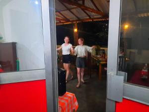 a couple of people standing in a mirror at Die Elefanten Udawalawe in Udawalawe