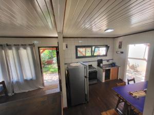 a kitchen with a refrigerator and a table in a trailer at Casa Rincón Del Viajero in Eldorado