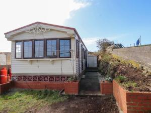 a tiny house sitting on top of a field at The Granada at Argraig in Holyhead