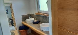 a bathroom with two white sinks on a counter at The Annexe in Kirkcudbright +6 photos
