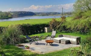 a patio with a table and chairs and a lake at The Annexe in Kirkcudbright