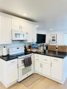 a kitchen with white cabinets and black counter tops at LVC0615 - Lake Therapy in Zephyr Cove