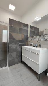 a bathroom with a white sink and a shower at Sicilia Meraviglia B&B in Fontane Bianche +48 photos