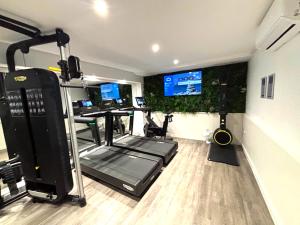 a room with a gym with two computers and a treadmill at Almondsbury Inn & Lounge in Almondsbury