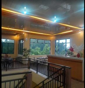 a large room with tables and chairs in a building at The Sanduk Inn in Rantepao +1 photo