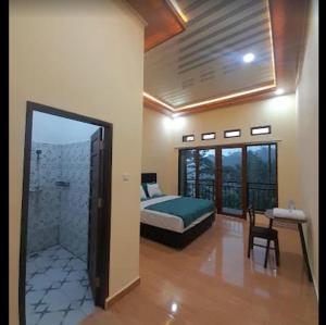 a bedroom with a bed and a walk in shower at The Sanduk Inn in Rantepao