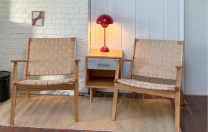 two chairs and a table with a red lamp on it at Amazing Home In Odder With Sauna in Odder