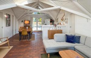 a living room with a couch and a table at Amazing Home In Odder With Sauna in Odder