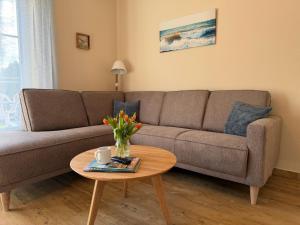 a living room with a couch and a table at Backhuus 3 in Fehmarn