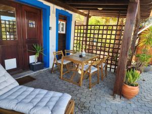 a wooden table and chairs on a patio at Casa Bella Studio in São Brás de Alportel