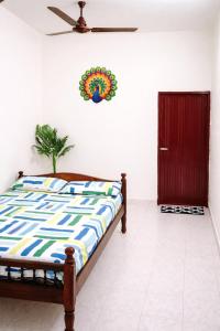 a bedroom with a bed and a door with areath on the wall at Vasan villa 2BHK in Pondicherry