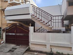 a white staircase with a gate in front of a building at Vasan villa 2BHK in Pondicherry
