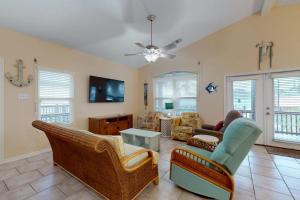 a living room with furniture and a ceiling fan at Take Me To The Beach in Rockport