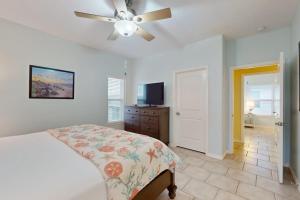 a bedroom with a bed and a ceiling fan at Take Me To The Beach in Rockport