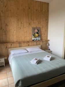 a bed with two towels on it in a bedroom at Relais Le Folaghe in Ladispoli