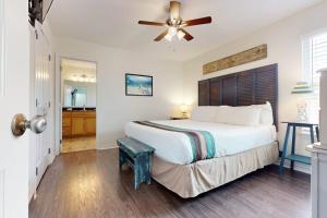 a bedroom with a large bed and a ceiling fan at South Pearl Sailfish in Rockport