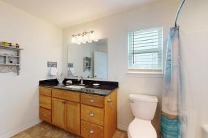 a bathroom with a sink and a toilet and a mirror at South Pearl Sailfish in Rockport +18 photos