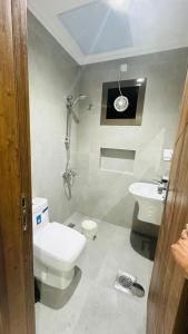 a bathroom with a toilet and a sink at Noble Rose Apartment in Kuwait