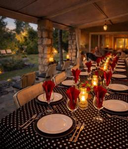 a long table with plates and wine glasses on it at Tarentaal Guest Farm Etosha National Park Namibia in Okaukuejo +76 photos
