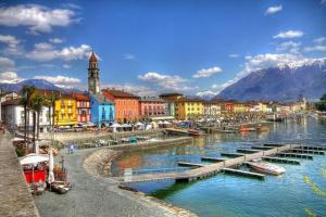 a city with a harbor with boats in the water at Ikigai Ascona in Ascona