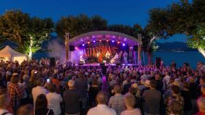 a large crowd of people watching a concert at night at Ikigai Ascona in Ascona
