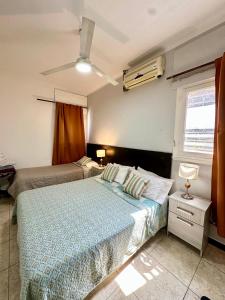 a bedroom with two beds and a window at Hotel Estrella Andina in San Juan