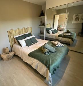 a bedroom with two beds and a large mirror at Résidence Petru-Maria in Propriano