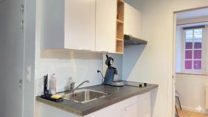 a kitchen with a sink and a counter top at KENDALL in Saint Malo